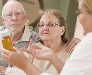 NP reviewing prescriptions with couple