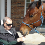  Ed Struve, an Agrace patient at Legacy Gardens, mentioned that before he died, he wished he could spend time with a horse. Ed had grown up on a ranch and had been around horses most of his life. Through the combined efforts of his Agrace care team, Legacy Gardens Administrator Rich Eggers, Kari Sasso of the UW–Madison Police Department and her horse, Vegas, Ed got his wish two days later. It was quite a sight to see the frail but happy man and the gentle horse together. Ed died the next day, his dream fulfilled.