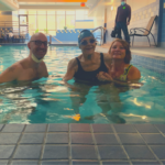 At 101, Betty wanted to be able to go swimming one more time.  A retired UW-Madison physical education and kinesiology professor, she was once an intercollegiate breaststroke champion in her native Canada. With some help from Capitol Lakes in Madison and coordination from the Agrace Wish program, Betty was able to swim six (!) laps in a warm water pool, accompanied by Agrace nurse, Ben, and her Agrace social worker, Michele. 