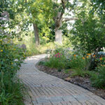 The Memorial Walk is flanked by lush plantings that add beauty in the warm months. 